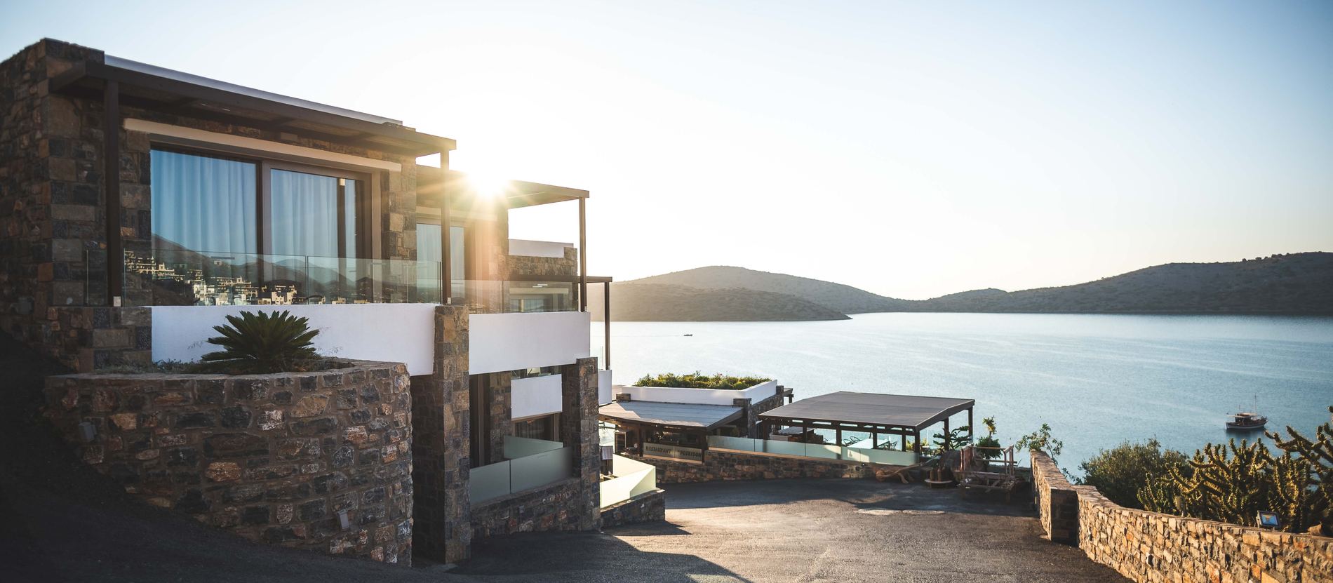 Abitazione moderna al tramonto, con ampie vetrate e ingresso automatizzato